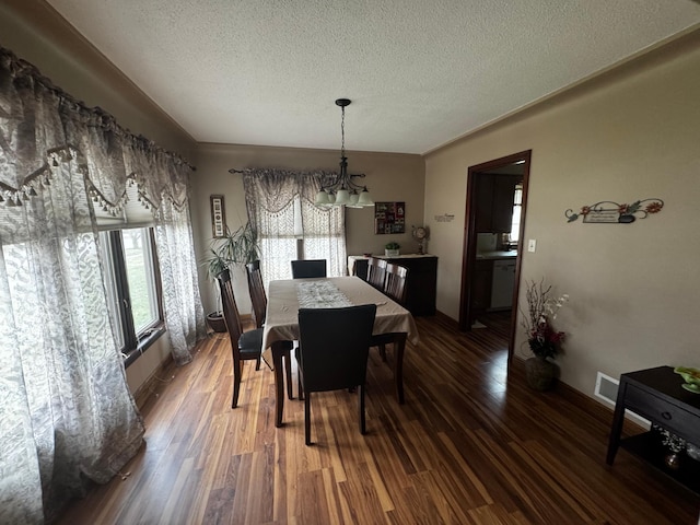 327 2nd St SW, Clara City, MN 56222 - dining area with healthy amount of natural light, a chandelier, a textured ceiling, and wood finished floors