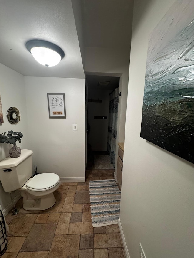 327 2nd St SW, Clara City, MN 56222 - full bathroom with stone tile flooring, toilet, and baseboards