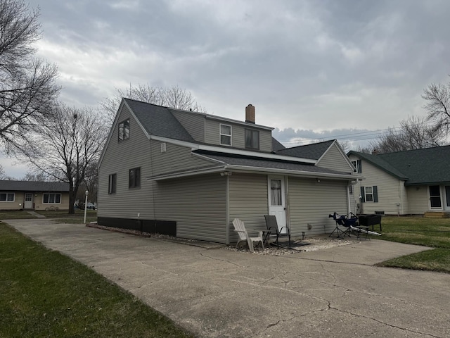 327 2nd St SW, Clara City, MN 56222 - rear view of house with a chimney and roof with shingles