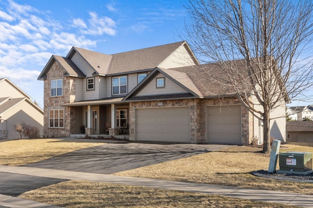 17639 Heidelberg Way, Lakeville, MN 55044 - craftsman-style house with stone siding, driveway, a porch, and a garage