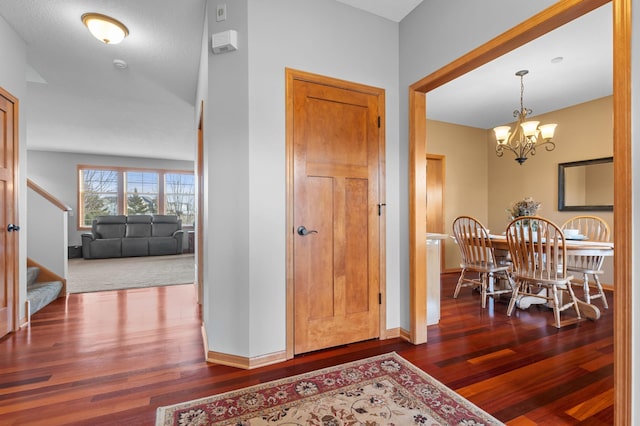 17639 Heidelberg Way, Lakeville, MN 55044 - foyer entrance with dark wood-style floors, a chandelier, baseboards, and stairs