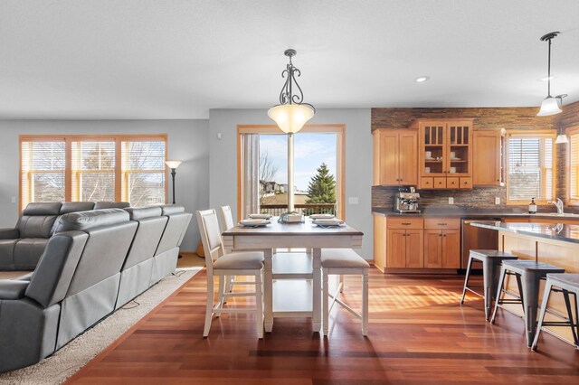 17639 Heidelberg Way, Lakeville, MN 55044 - kitchen featuring dishwasher, open floor plan, wood finished floors, glass insert cabinets, and light brown cabinetry