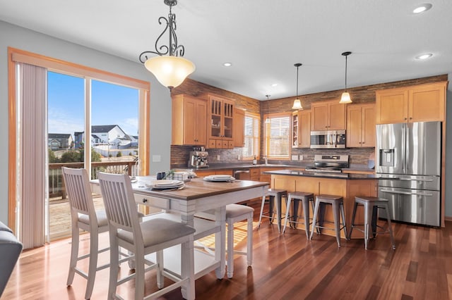 17639 Heidelberg Way, Lakeville, MN 55044 - kitchen featuring appliances with stainless steel finishes, dark countertops, backsplash, wood finished floors, and recessed lighting