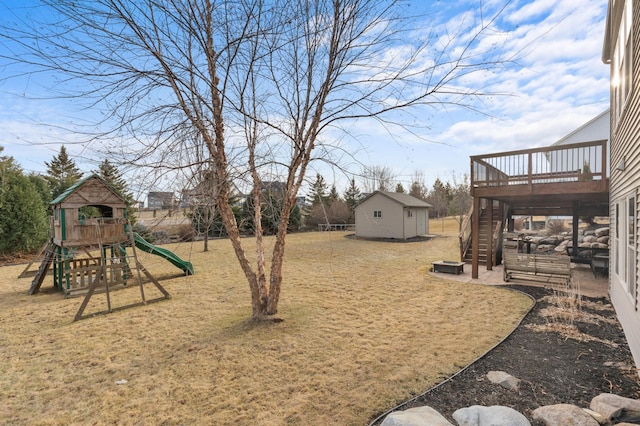 17639 Heidelberg Way, Lakeville, MN 55044 - view of grassy yard featuring stairs, a wooden deck, an outbuilding, and a playground