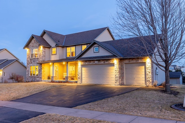 17639 Heidelberg Way, Lakeville, MN 55044 - craftsman-style home with stone siding, driveway, a garage, and a shingled roof