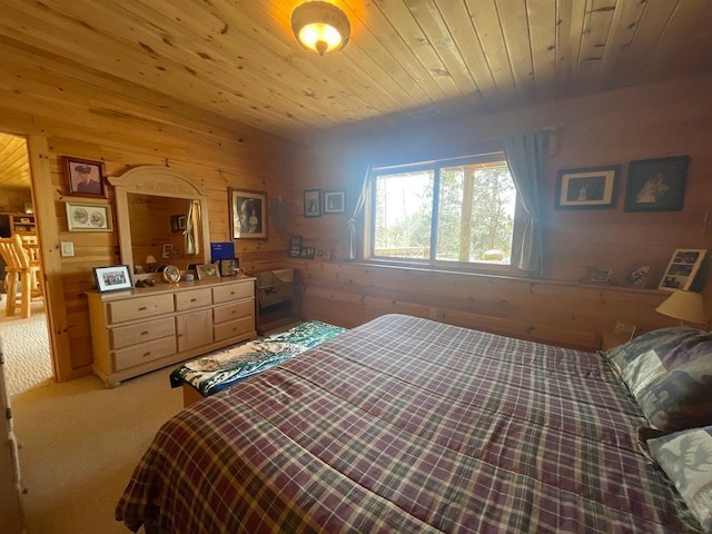 17999 Ivy Dr, Park Rapids, MN 56470 - bedroom with wooden walls, light colored carpet, and wooden ceiling
