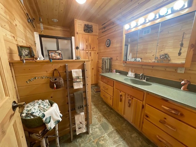 17999 Ivy Dr, Park Rapids, MN 56470 - bathroom featuring wooden walls, wood ceiling, vanity, stone finish flooring, and an enclosed shower