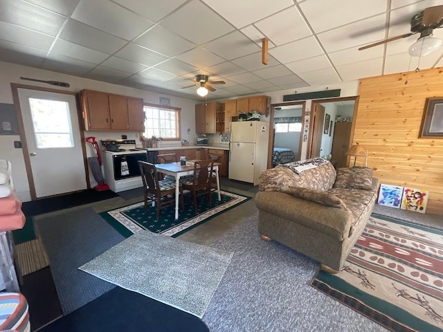 17999 Ivy Dr, Park Rapids, MN 56470 - living room featuring ceiling fan, a drop ceiling, and wood walls