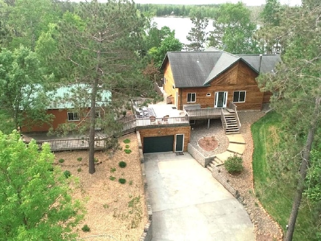 17999 Ivy Dr, Park Rapids, MN 56470 - view of front facade featuring a wooden deck, driveway, stairway, and an attached garage