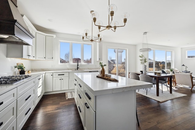 4240 Inland Ln N, Plymouth, MN 55446 - kitchen featuring premium range hood, a kitchen island, stainless steel gas cooktop, a chandelier, and dark wood-style flooring