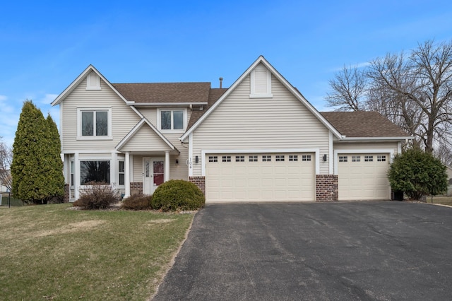 104 Birch Ave NW, Saint Michael, MN 55376 - traditional home with asphalt driveway, brick siding, a garage, a front lawn, and roof with shingles