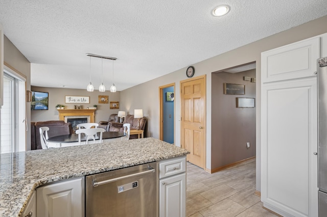 104 Birch Ave NW, Saint Michael, MN 55376 - kitchen featuring dishwasher, a textured ceiling, open floor plan, white cabinetry, and a glass covered fireplace