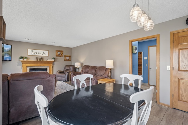 104 Birch Ave NW, Saint Michael, MN 55376 - dining space featuring a textured ceiling, a fireplace, and light tile patterned floors