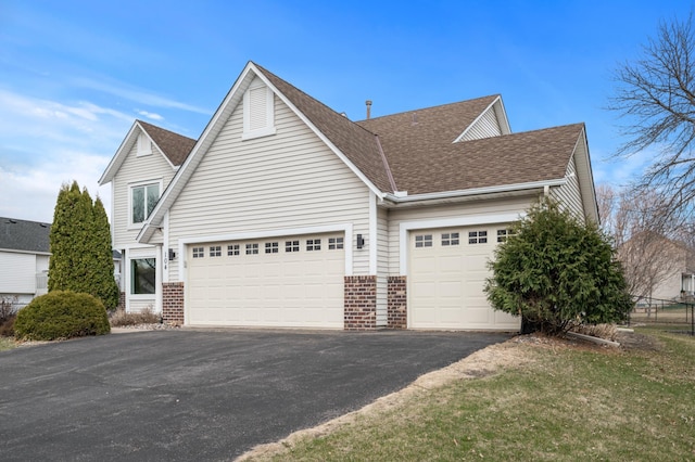 104 Birch Ave NW, Saint Michael, MN 55376 - view of front facade featuring brick siding, driveway, a garage, and roof with shingles