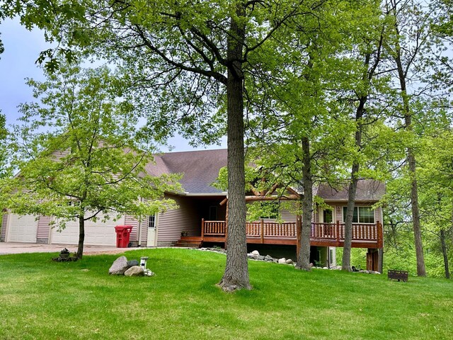 7621 Winter Trl, Breezy Point, MN 56472 - rear view of house featuring a yard, a deck, an attached garage, and driveway