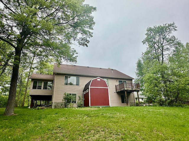 7621 Winter Trl, Breezy Point, MN 56472 - rear view of house with a yard, a barn, a wooden deck, and an outbuilding