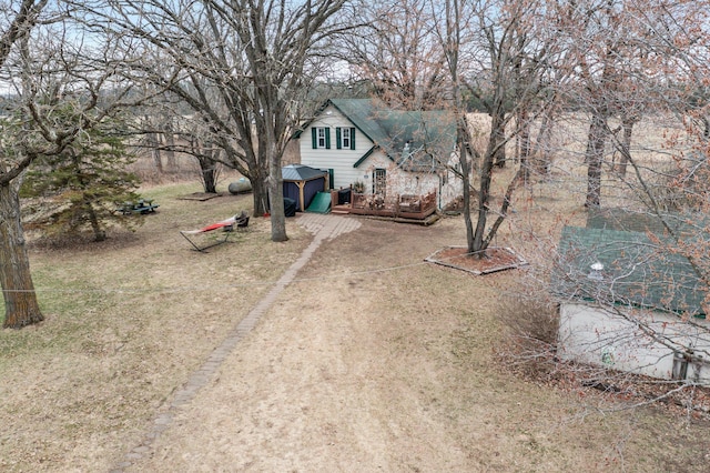 view of yard featuring driveway and a deck