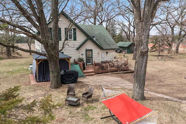 rear view of property with a wooden deck