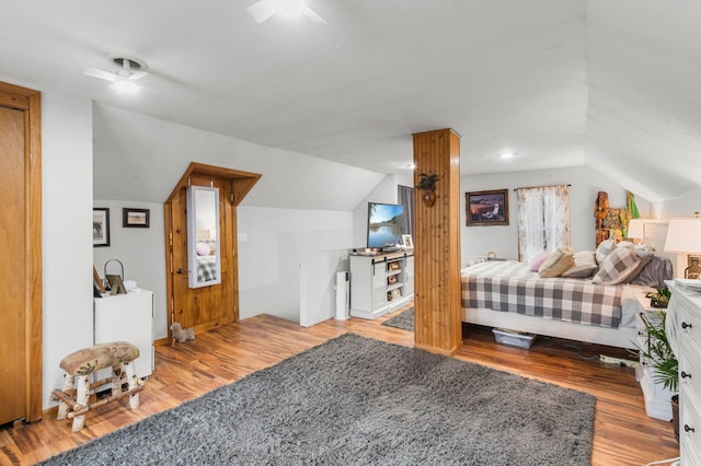bedroom featuring lofted ceiling, a ceiling fan, and wood finished floors