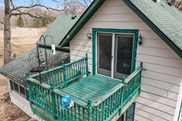 rear view of house with roof with shingles
