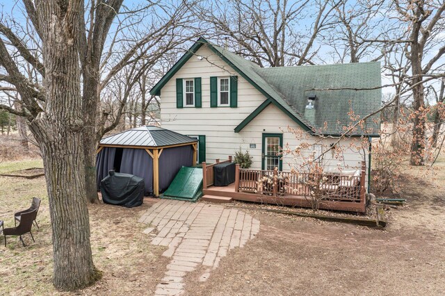 2908 River Rd, Saint Croix Falls, WI 54024 - back of property with a gazebo, a wooden deck, and roof with shingles