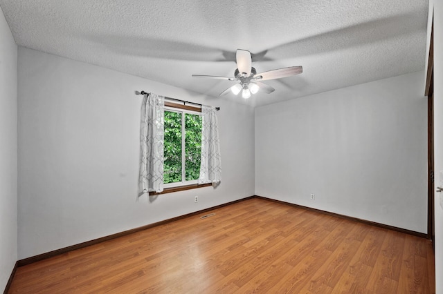 11560 Red Fox Dr, Maple Grove, MN 55369 - spare room featuring wood finished floors, a ceiling fan, baseboards, and a textured ceiling