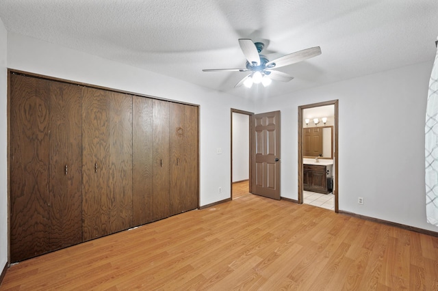 11560 Red Fox Dr, Maple Grove, MN 55369 - unfurnished bedroom featuring light wood-style flooring, a closet, baseboards, ensuite bath, and a ceiling fan