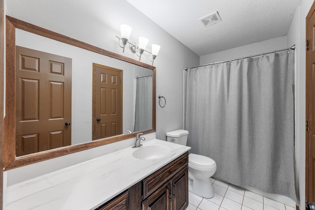 11560 Red Fox Dr, Maple Grove, MN 55369 - bathroom featuring toilet, vanity, tile patterned flooring, and a textured ceiling