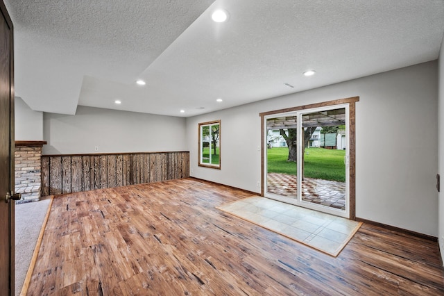 11560 Red Fox Dr, Maple Grove, MN 55369 - spare room with wood finished floors, a textured ceiling, recessed lighting, and baseboards