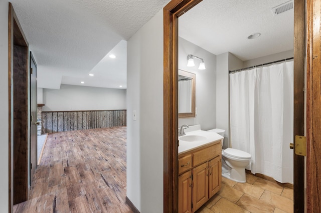 11560 Red Fox Dr, Maple Grove, MN 55369 - bathroom with toilet, vanity, a textured ceiling, and recessed lighting