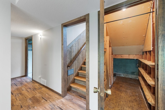11560 Red Fox Dr, Maple Grove, MN 55369 - stairs featuring baseboards, a textured ceiling, and wood finished floors