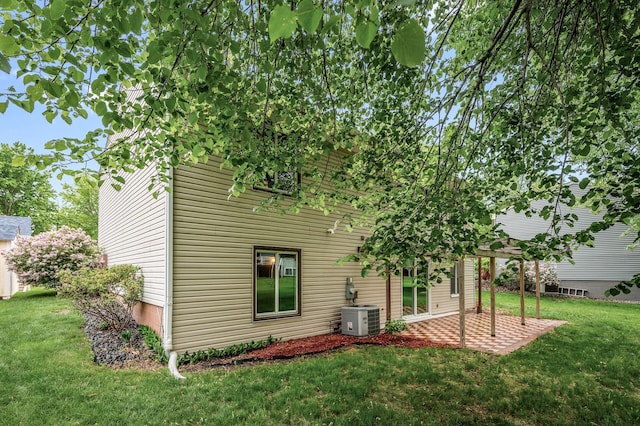 11560 Red Fox Dr, Maple Grove, MN 55369 - back of property featuring central AC, a lawn, and a patio area