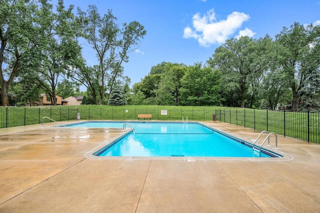 11560 Red Fox Dr, Maple Grove, MN 55369 - community pool featuring a patio and view of wooded area