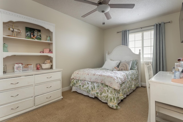 bedroom with ceiling fan, light carpet, and a textured ceiling
