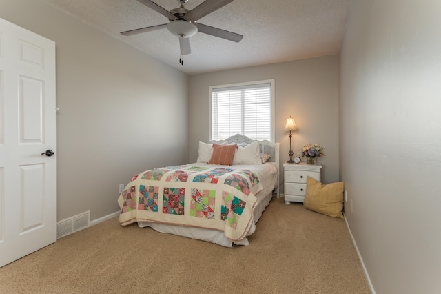 bedroom featuring visible vents, baseboards, ceiling fan, a textured ceiling, and carpet flooring