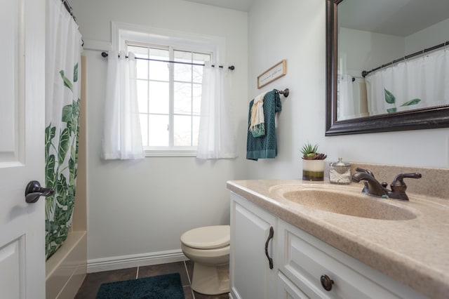bathroom with toilet, baseboards, tile patterned flooring, and vanity