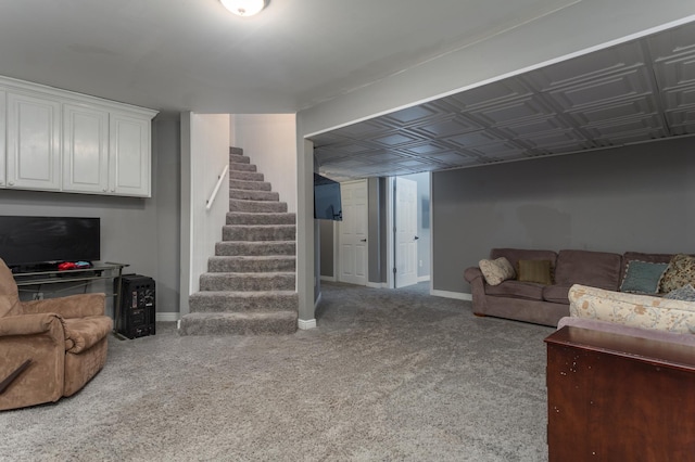 living room featuring baseboards, stairs, and carpet floors