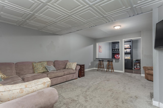 carpeted living area featuring baseboards