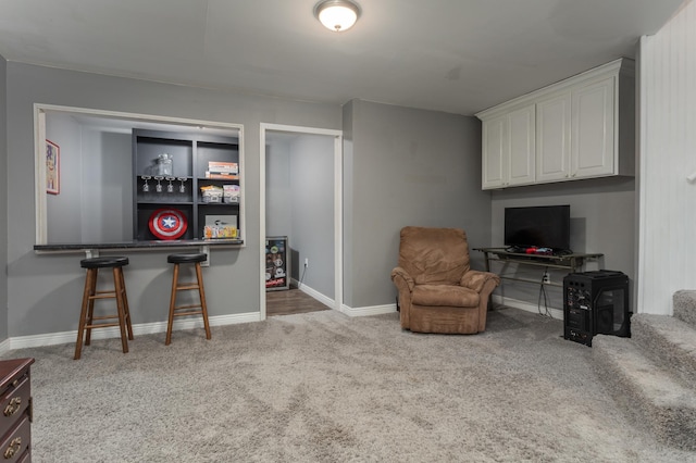 living area featuring carpet floors and baseboards