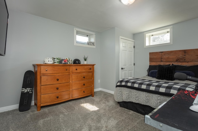 bedroom featuring baseboards and carpet