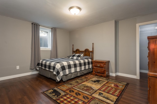 bedroom with baseboards and dark wood-style floors