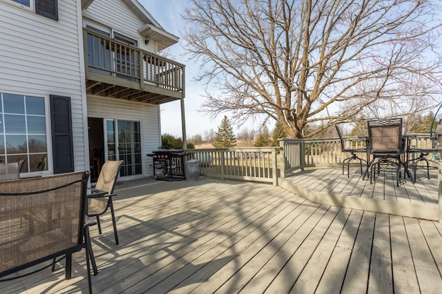 wooden terrace featuring outdoor dining area