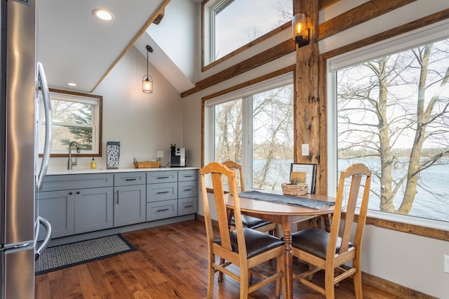 dining area featuring dark wood-type flooring and vaulted ceiling