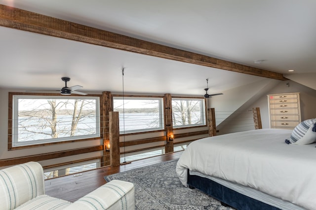 bedroom featuring lofted ceiling with beams and wood finished floors