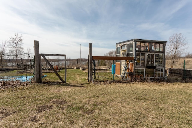 view of play area with a lawn, exterior structure, and an outbuilding
