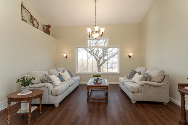 living room with baseboards, an inviting chandelier, and wood finished floors