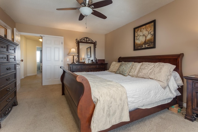 bedroom featuring light colored carpet and ceiling fan