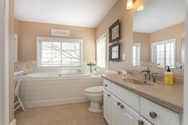 full bathroom featuring vanity, tile patterned flooring, toilet, and a bath