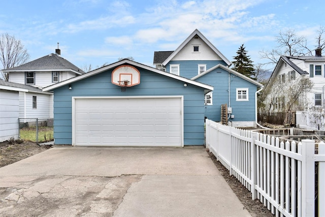 view of front of property featuring fence, an outbuilding, and a detached garage