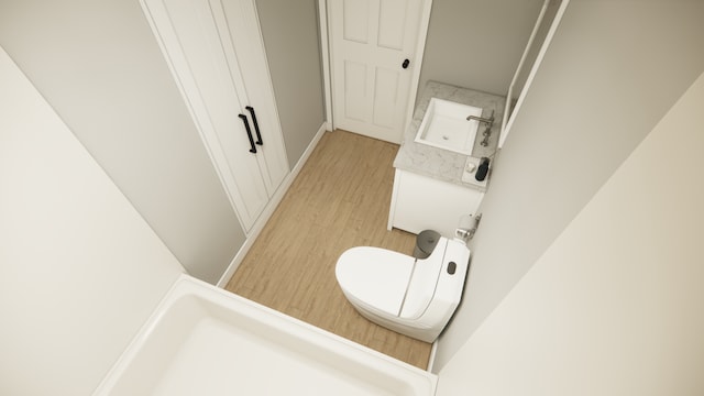 1025 3rd Ave NE, Milaca, MN 56353 - bathroom featuring wood finished floors, toilet, and a sink
